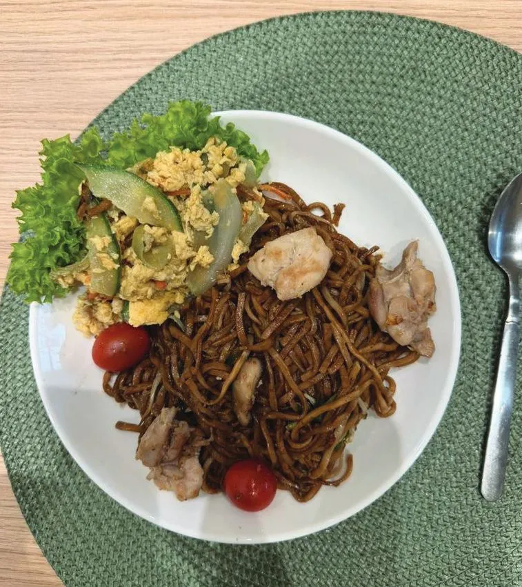 A TITAN lunch of fried noodles with chicken, egg and salad