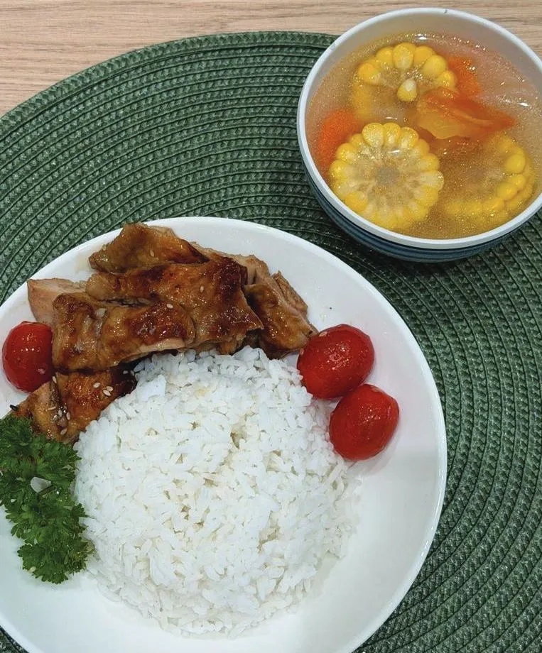 A TITAN lunch of rice with glazed chicken, tomatoes and a bowl of corn and carrot soup