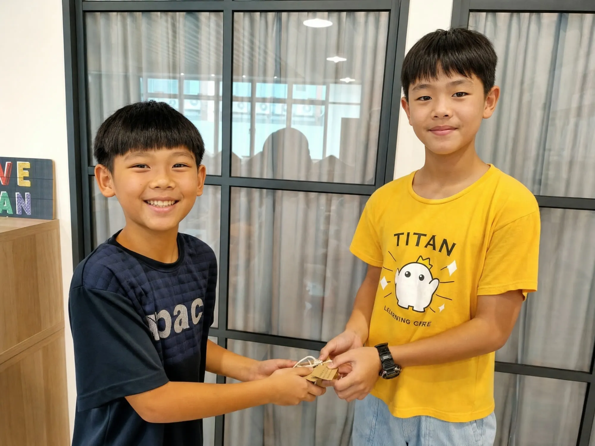 A TITAN student handing something to a classmate