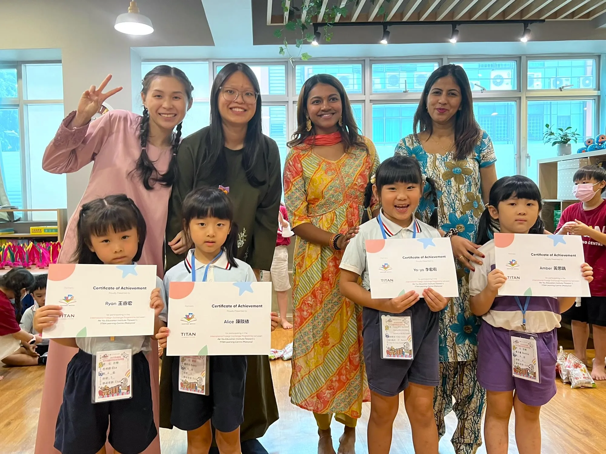 TITAN educators with four students holding their certificates of achievement